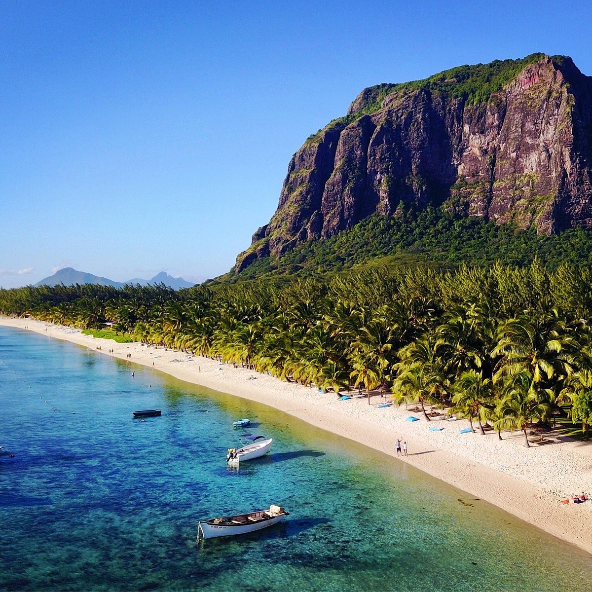 Le Morne beach with boats in shallow water