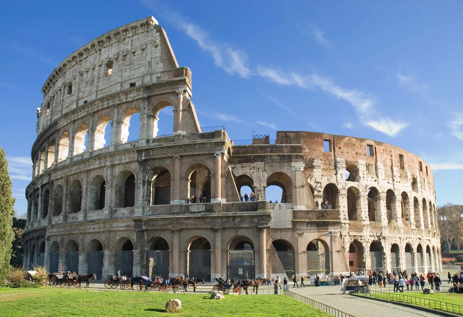 The Colosseum in Rome under a blue sky