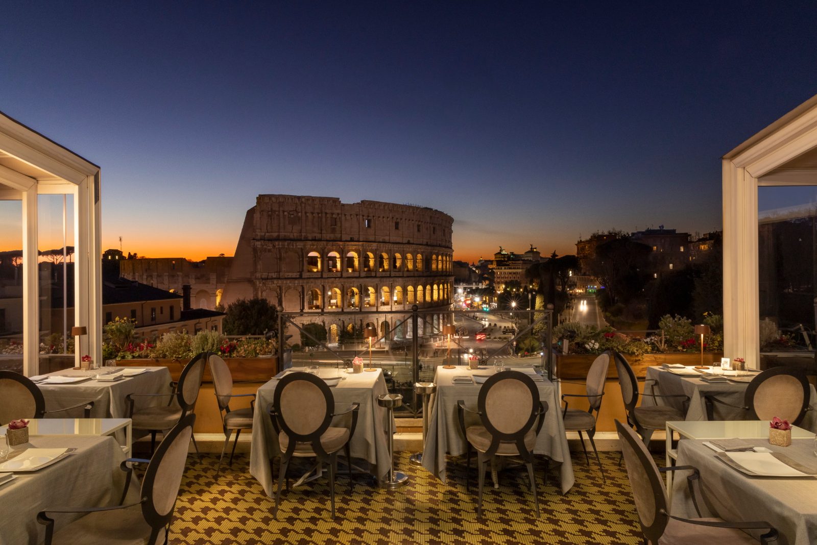 Rooftop terrace at Aroma restaurant facing the Colosseum at dusk