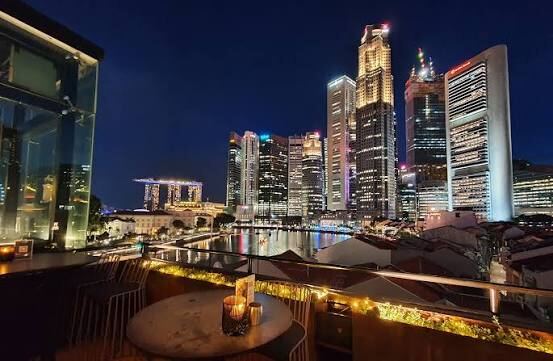 Rooftop bar view over the Singapore River and CBD skyline at night